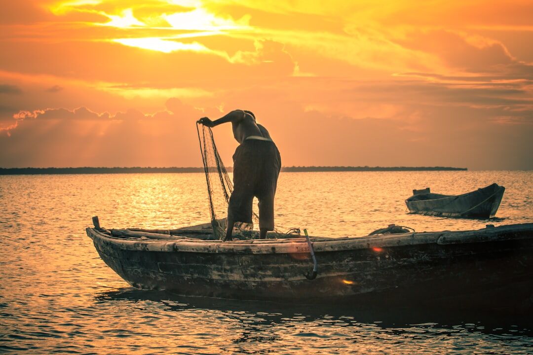 fisherman on boat at dawn