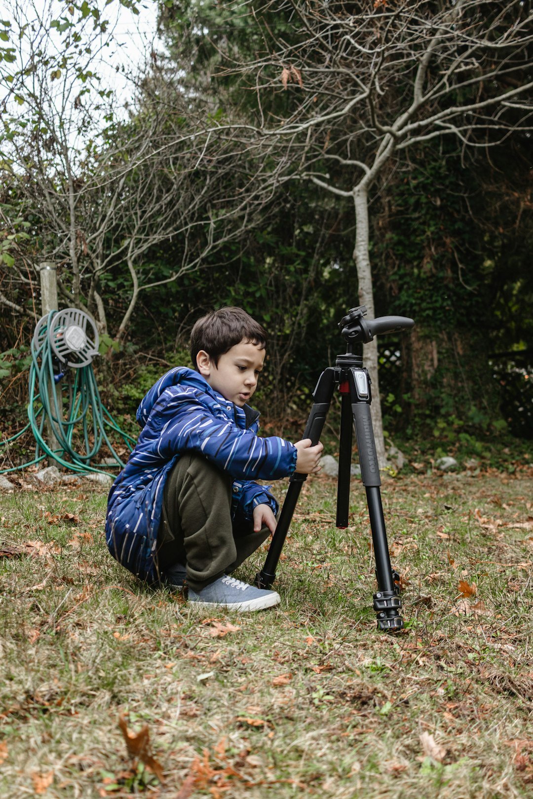 Photographer crouching to photograph a child at eye level